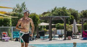 Sports instructor during aqua aerobics, campsite with pool in Corsica